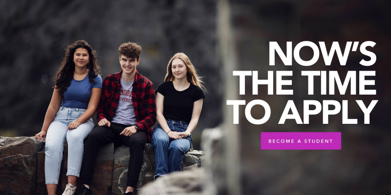 Three Memorial University students sit side by side on large rocks outdoors, smiling at the camera, with overlaid text reading “Now’s the time to apply” and a “Become a student” purple call-to-action button.
